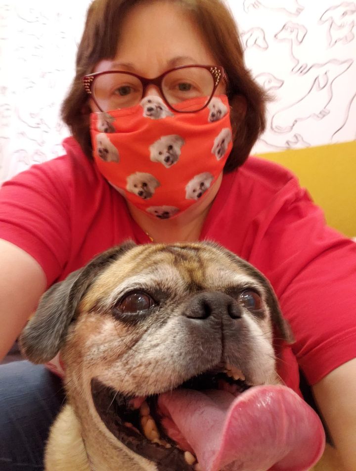 Betsy the pug and masked volunteer pug and masked volunteer