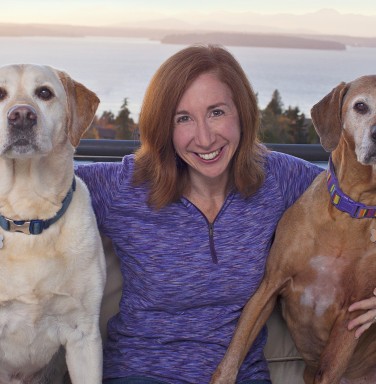 brown haired woman with two dogs