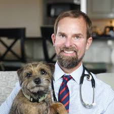 brown haired male doctor with dog