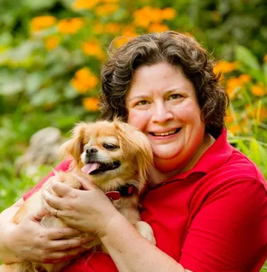 Julie Dudley holding her little dog