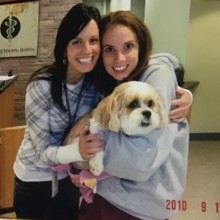 two girls holding dog