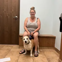 dog and person sitting on bench