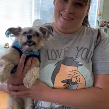 dog and his mom smiling