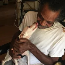 senior man holding senior dog