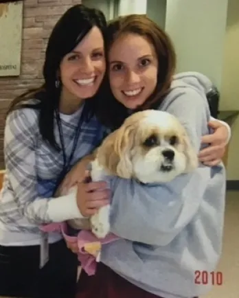 two girls holding dog