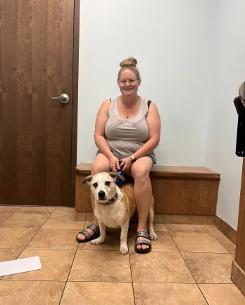 dog and person sitting on bench