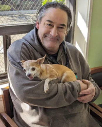 Man holding small dog