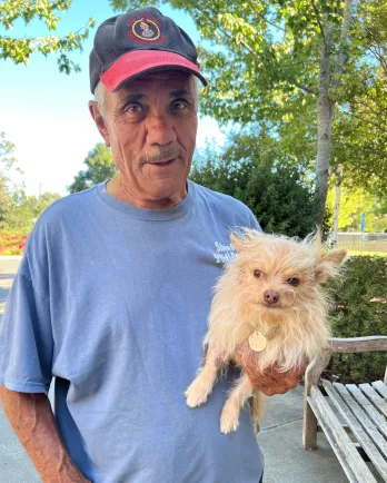 Man holding small dog