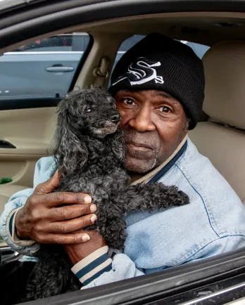 Man holding small dog