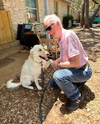 dog and man shaking hand/ paw