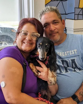 Dachshund with two people