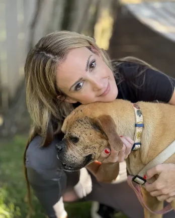 brown dog with blonde woman