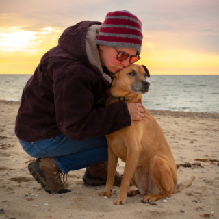 Hugging Dog on Beach