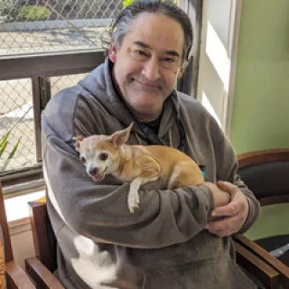 Man holding small dog