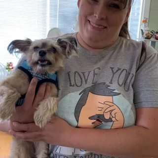 dog and his mom smiling