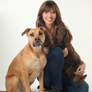 brown haired woman with two dogs